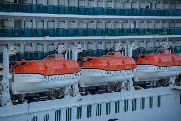 Close-up view of lifeboats on a cruise ship, highlighting safety equipment.- The Essential Cruise Sop Blog
