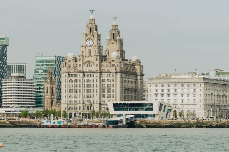 Scenic view of Liverpool's Royal Liver Building at the waterfront, showcasing architectural elegance - The Essential Cruise Shop Blog