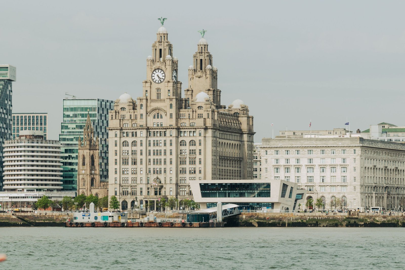 Scenic view of Liverpool's Royal Liver Building at the waterfront, showcasing architectural elegance - The Essential Cruise Shop Blog